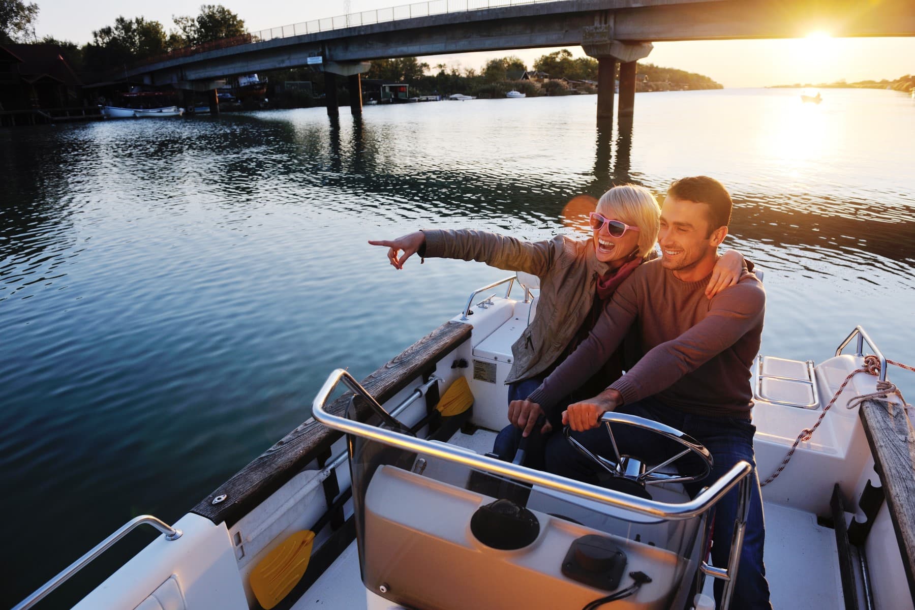Couple riding boat sunset