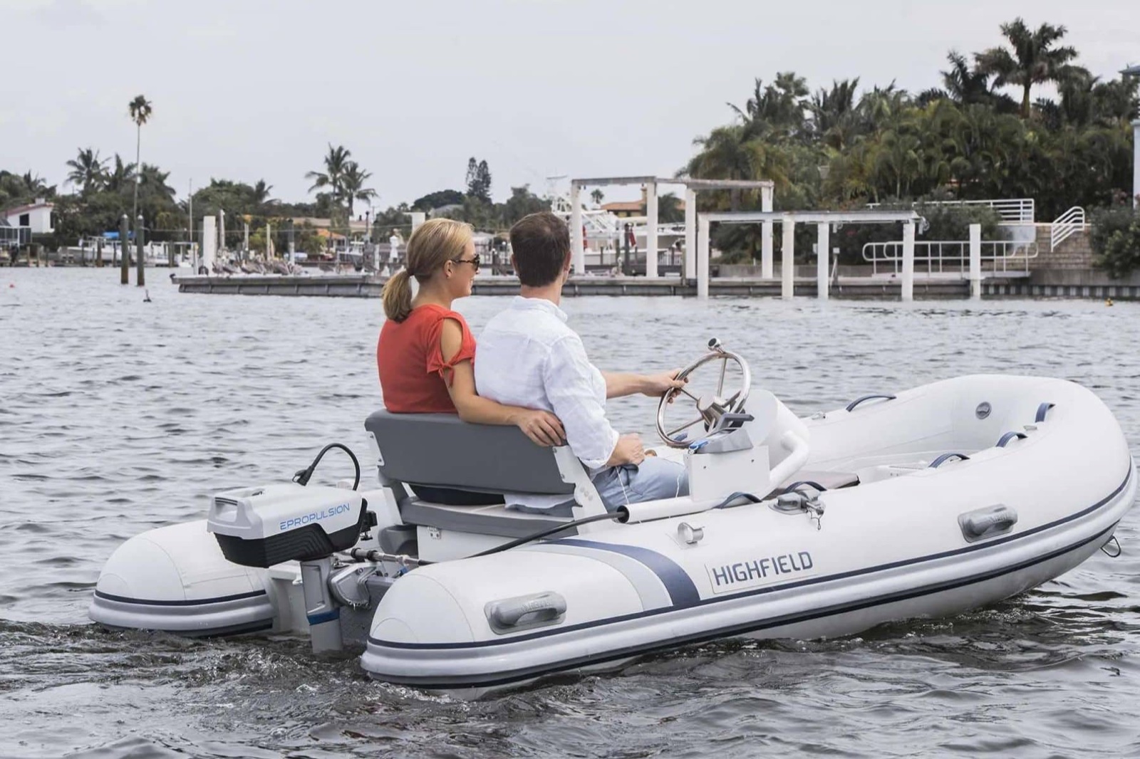 Electric outboard motor mounted on a tender at the dock